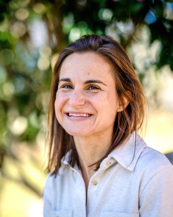 Jessica Magidson smiling outdoors in front of trees